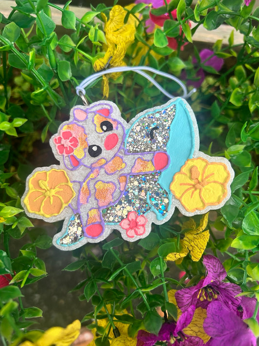 Hand-painted cow riding a sparkling blue dolphin, surrounded by colorful tropical flowers, made-to-order scented freshie
