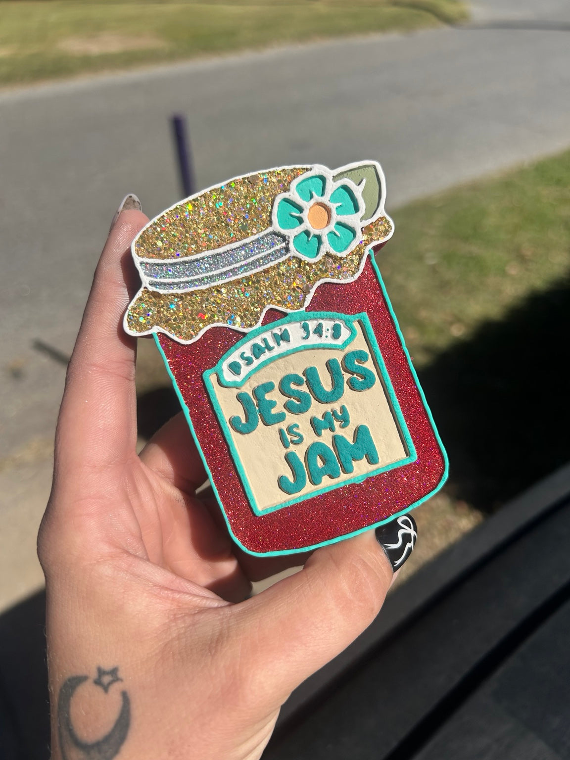 Hand-painted Jesus Is My Jam scented freshie shaped like a jam jar with gold glitter lid, turquoise flower, and red jar body