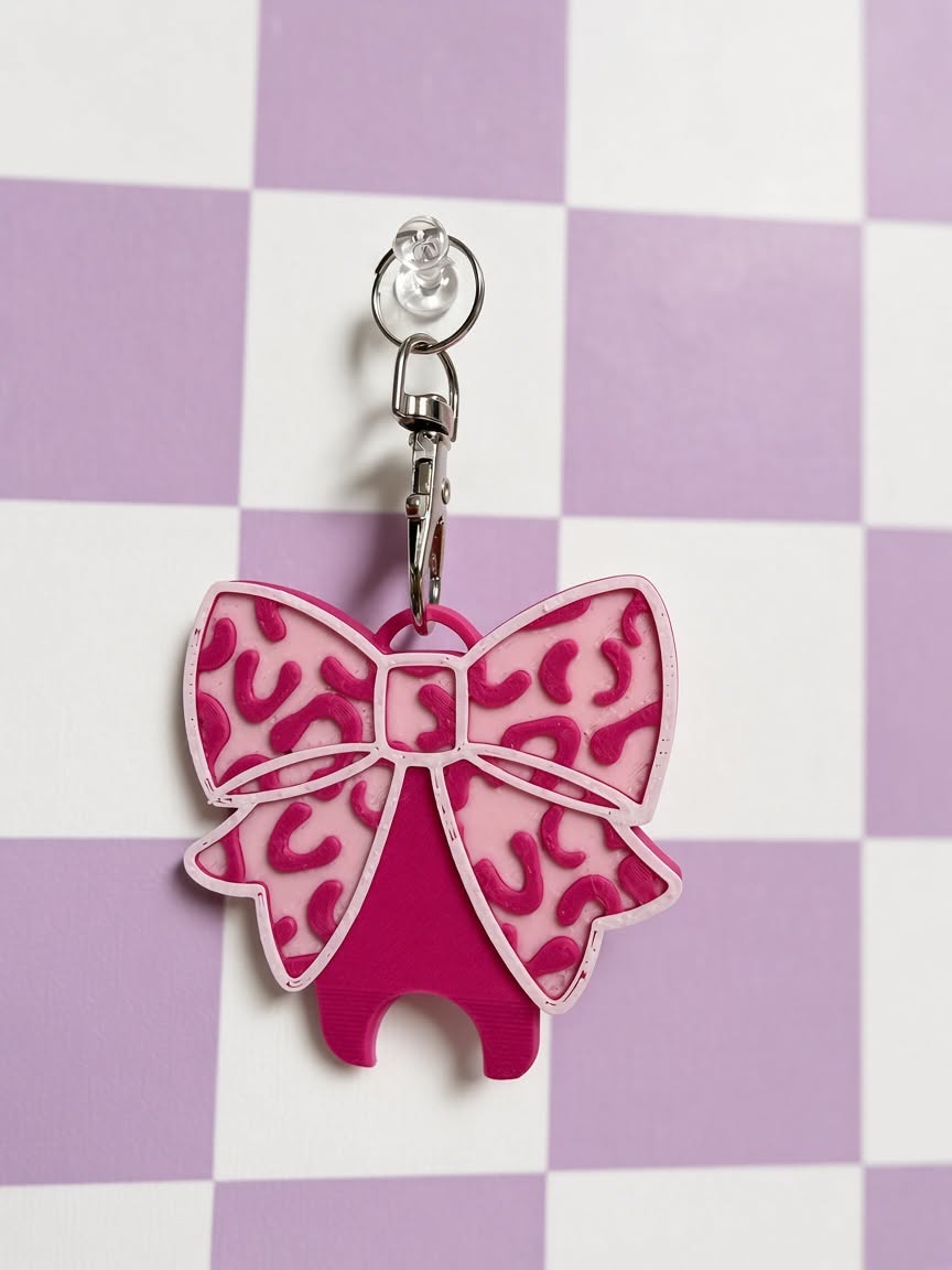 Pink bow nail saver with keychain clip